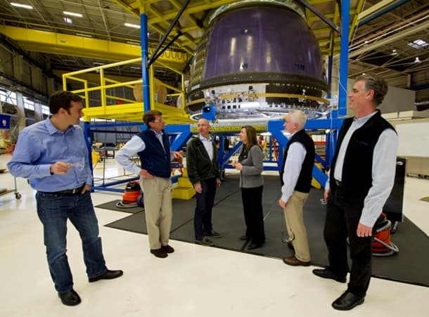 Jeff Bezos stands with former NASA Deputy Administer Lori Garver and Blue Origin employees in the High Bay in Kent, WA.