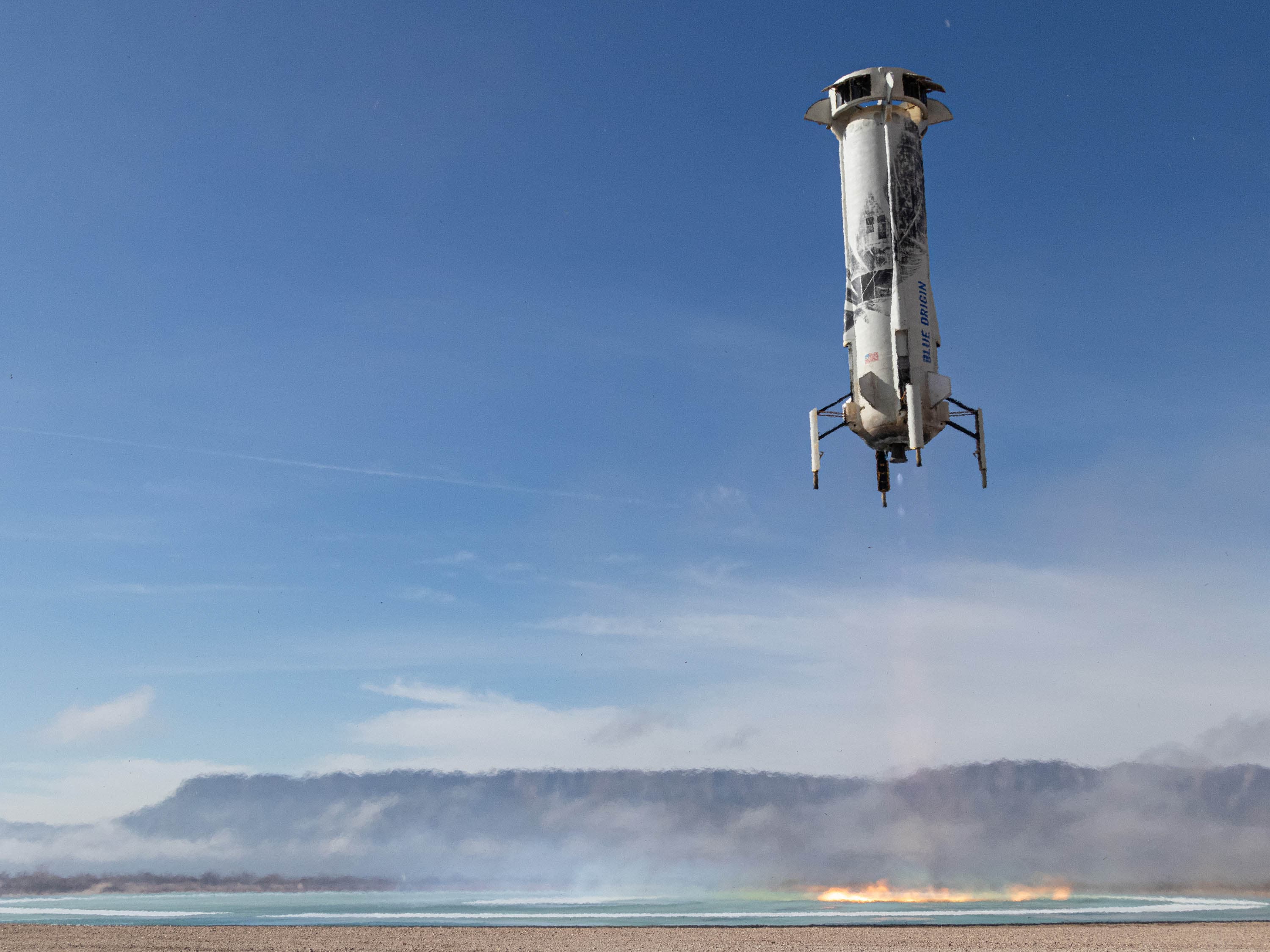New Shepard's booster descends on the landing pad in West Texas.