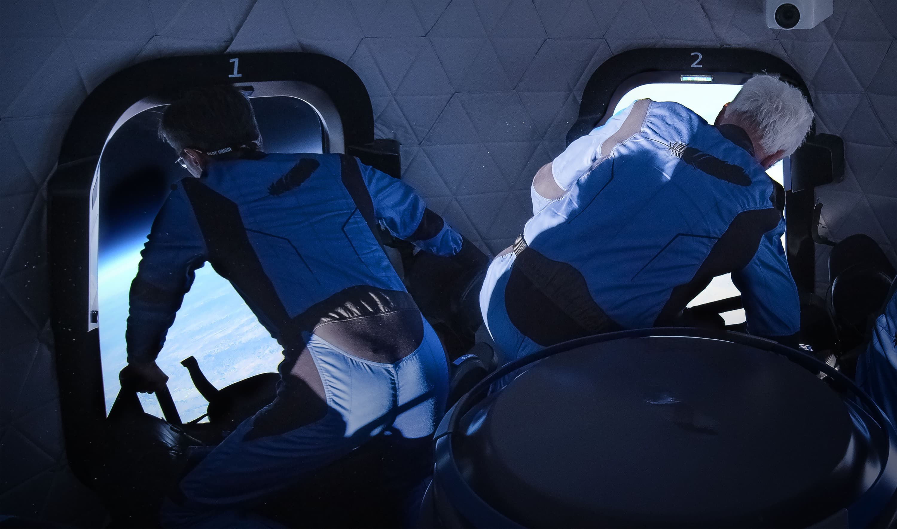 Gary and George gaze outside the windows looking at Earth from space.